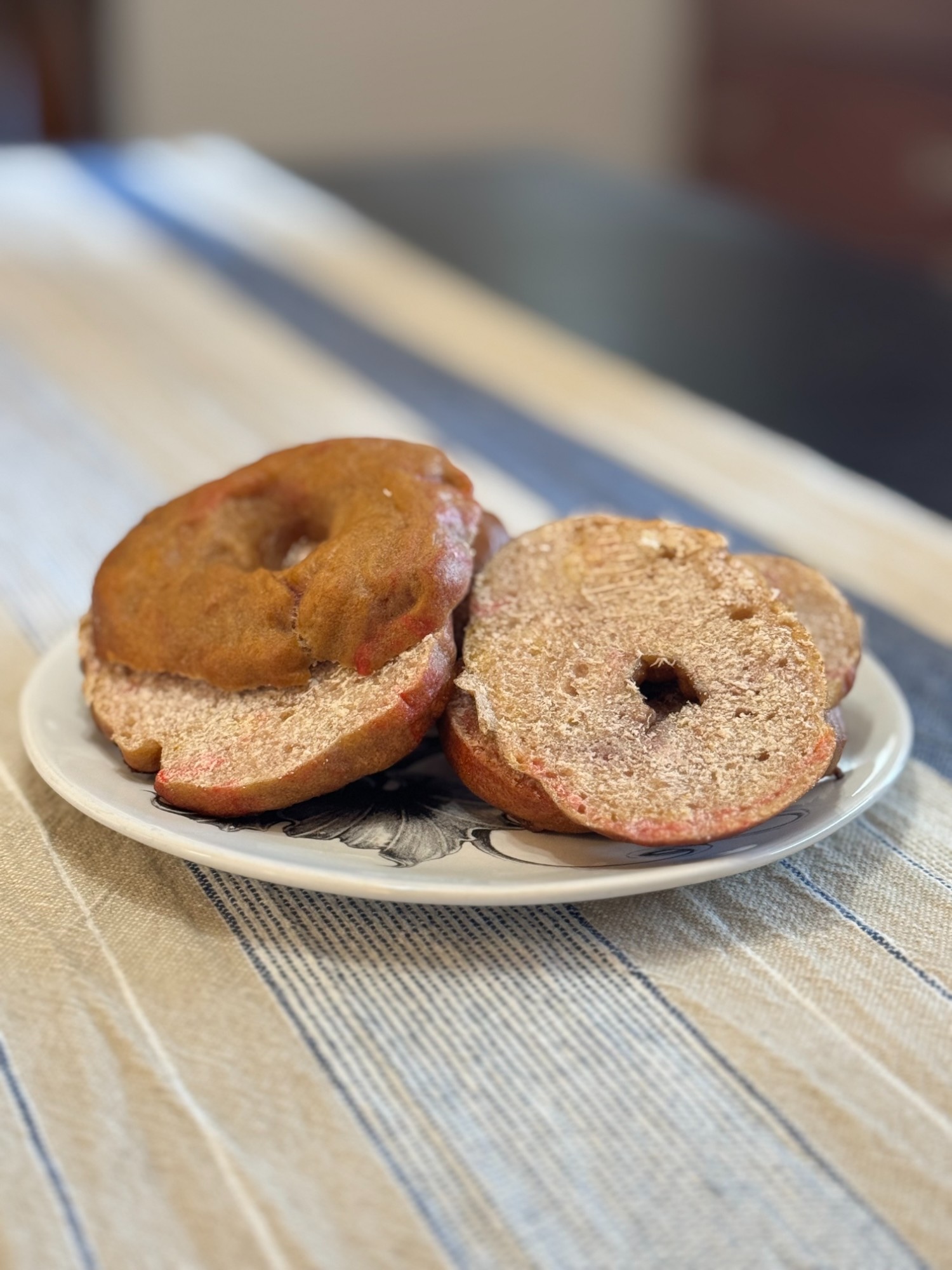 Beautiful strawberry sourdough bagels on a floral plate