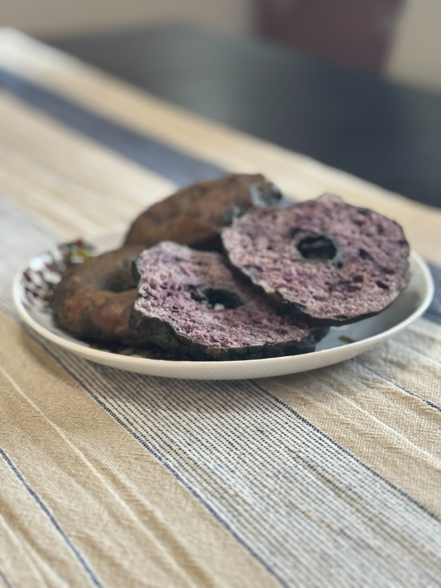 Fresh blueberry sourdough bagels arranged in a basket — the reward of a first successful bake week